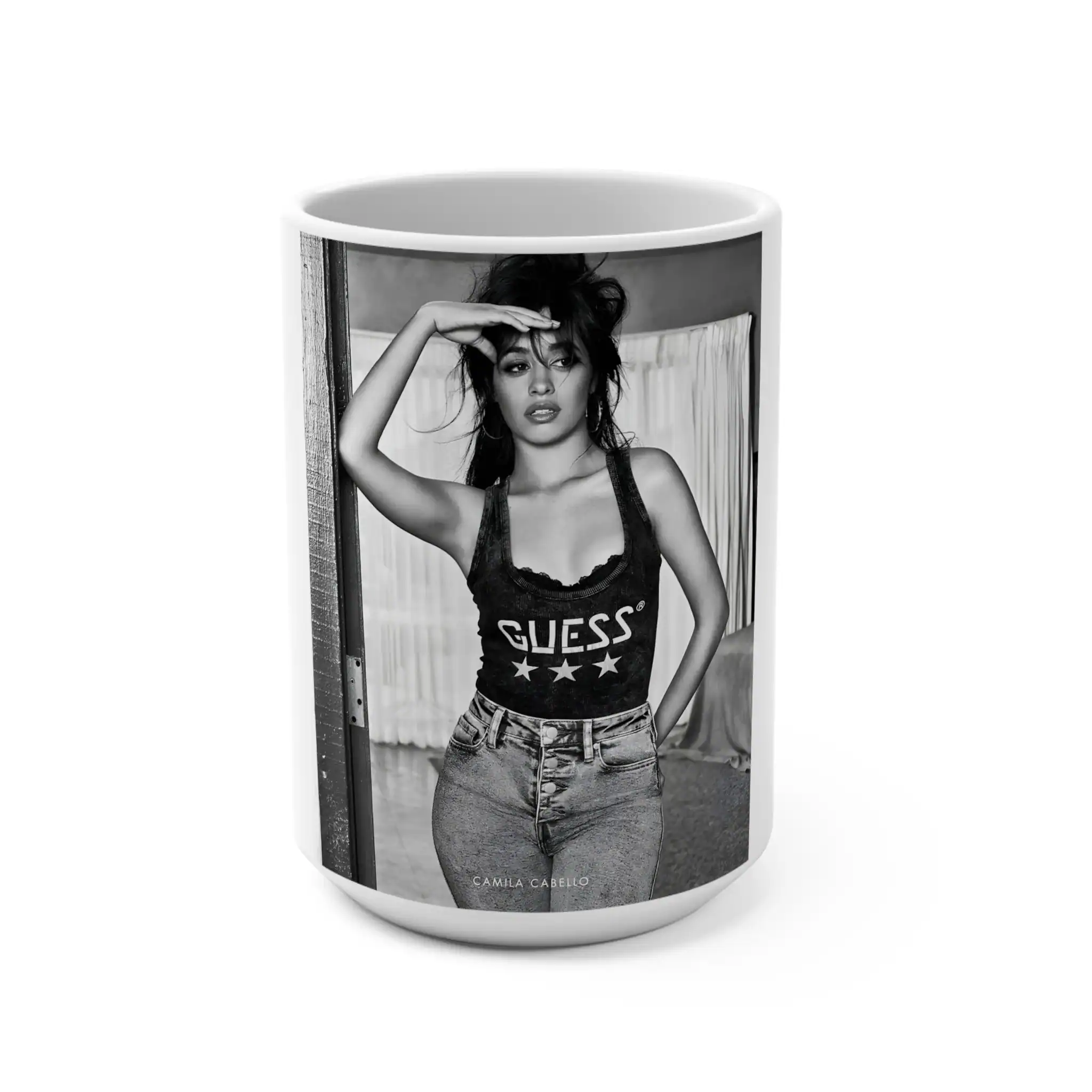 Camila Cabello wearing Guess tank top and high-waisted jeans, stylish casual outfit, black and white photo, fashion modeling.