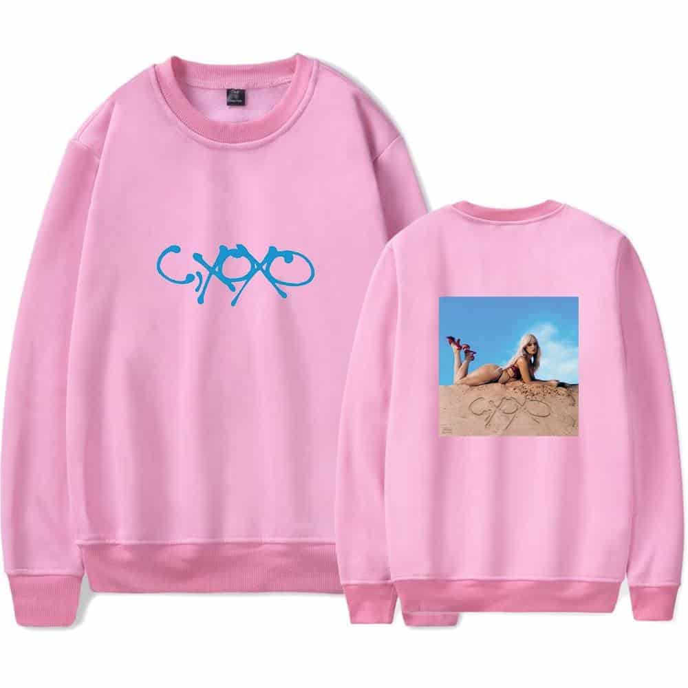 Bright pink sweatshirt featuring Camila Cabello's logo on the front and a photo of her lying on the beach on the back.